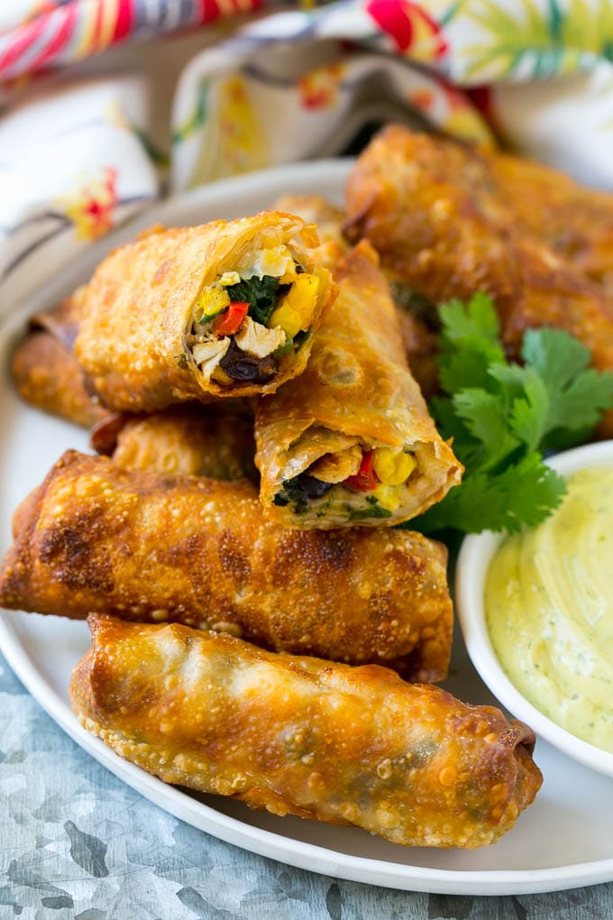 Southwestern Egg Rolls Recipe | Easy Egg Roll Recipe | Mexican Appetizer | Egg Roll Recipe | Southwest Egg Rolls #eggrolls #appetizer #chicken #snack #edsug Morsels stuffed with diced chicken, bell peppers, black beans and cheese on a serving plate.