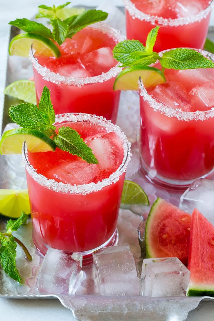 Watermelon Agua Fresca | Watermelon Drink | Agua Fresca Recipe #watermelon #aguafresca #watermelondrink #drink #edsug #summer Watermelon agua fresca in sugar rimmed glasses with lime and mint for garnish.