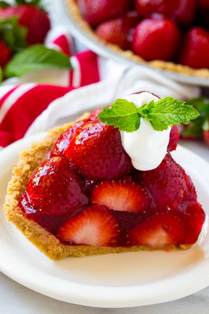 No Bake Strawberry Pie Recipe | Fresh Strawberry Pie | Strawberry Pie Recipe | No Bake Pie Recipe #strawberry #strawberrypie #nobake #nobakepie #dessert #edsug A slice of no bake fresh strawberry pie with whipped cream on top.
