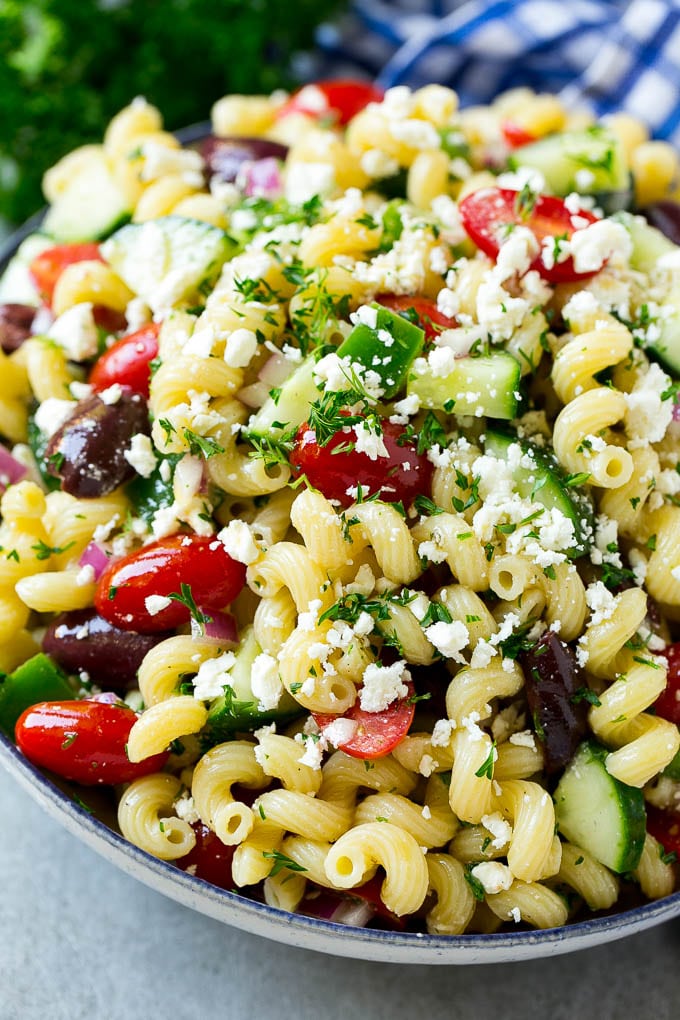 Greek Pasta Salad | Easy Pasta Salad | Vegetable Pasta Salad #pasta #salad #greek #cucumber #tomato #vegetarian #dinner #edsug A bowl of Greek pasta salad loaded with feta cheese, olives, tomatoes, cucumber and bell peppers.