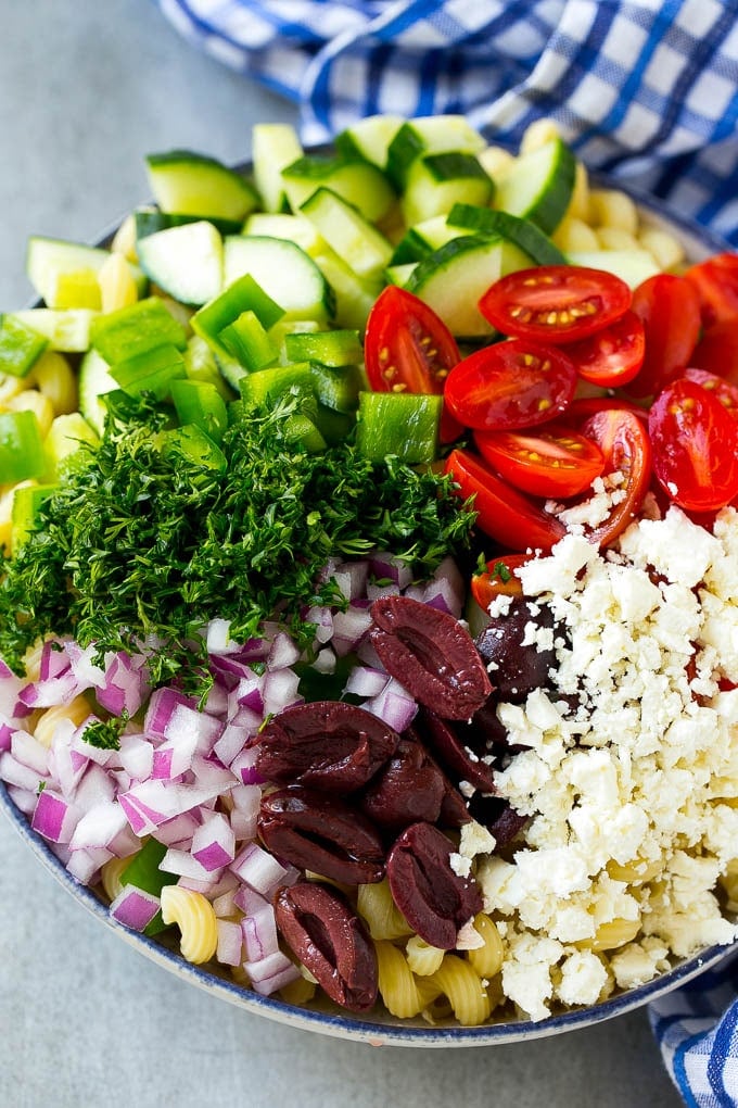 Greek Pasta Salad | Easy Pasta Salad | Vegetable Pasta Salad #pasta #salad #greek #cucumber #tomato #vegetarian #dinner #edsug Cherry tomatoes, bell pepper, olives, feta, herbs and cucumbers over pasta.