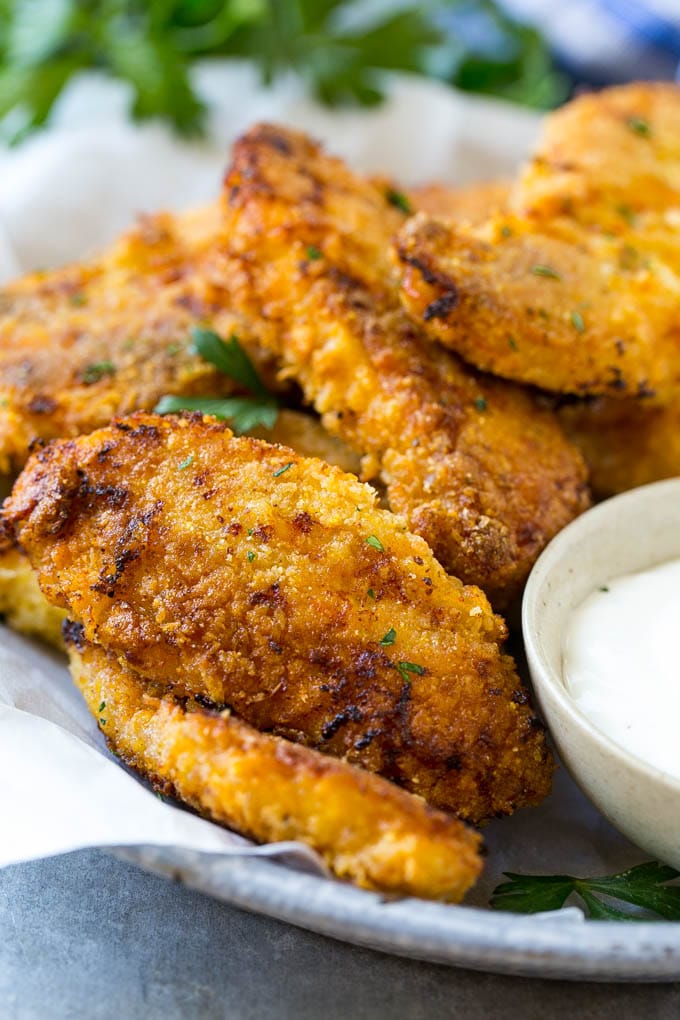 Baked Fried Chicken Recipe | Oven Fried Chicken | Baked Chicken Fingers | Crispy Chicken Fingers #chicken #friedchicken #bakedchicken #ovenfriedchicken #chickenfingers #dinner #edsug Baked oven fried chicken fingers in a dish with a side of ranch dressing.
