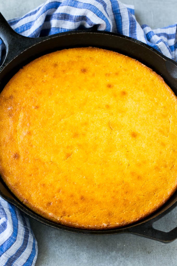 Honey Cornbread Recipe | Buttermilk Cornbread | Easy Cornbread | Homemade Cornbread | Cast Iron Cornbread #cornbread #honey #buttermilk #bread #edsug A cast iron pan of honey cornbread.