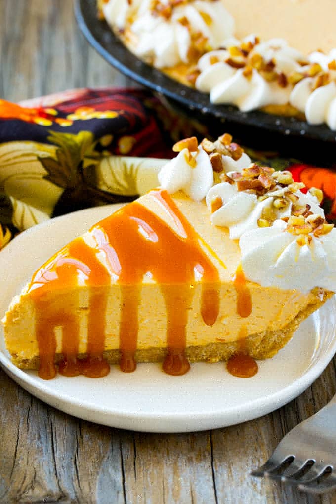 No Bake Pumpkin Cheesecake Recipe | Pumpkin Cheesecake | No Bake Cheesecake | Thanksgiving Dessert | Pumpkin Dessert #nobake #cheesecake #pumpkin #pumpkinpie #pumpkincheesecake #nobakecheesecake #dessert #edsug A piece of no bake pumpkin flavored cheesecake topped with caramel.