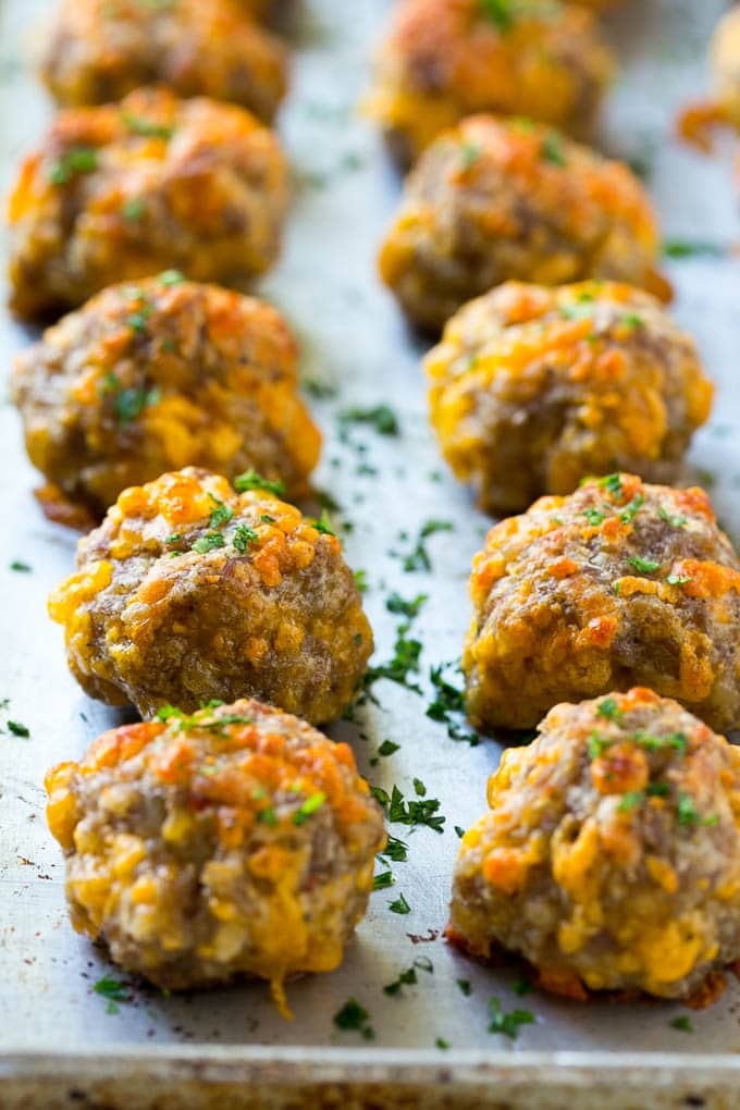 Sausage Cheese Balls Recipe | Sausage Balls Recipe | Bisquick Sausage Balls #sausage #sausageballs #balls #appetizer #cheeseballs #edsug Cooked meatballs on a baking sheet.