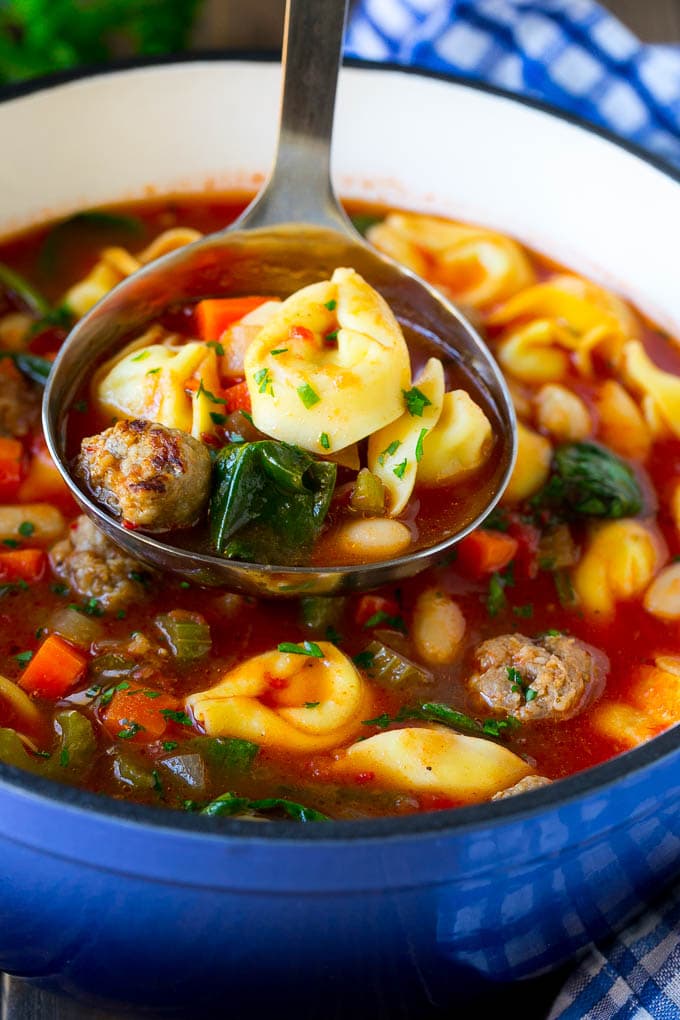 Tortellini Soup Recipe | Sausage Soup | Italian Soup #soup #sausage #pasta #tortellini #dinner #edsug A ladle serving up a portion of tortellini soup.