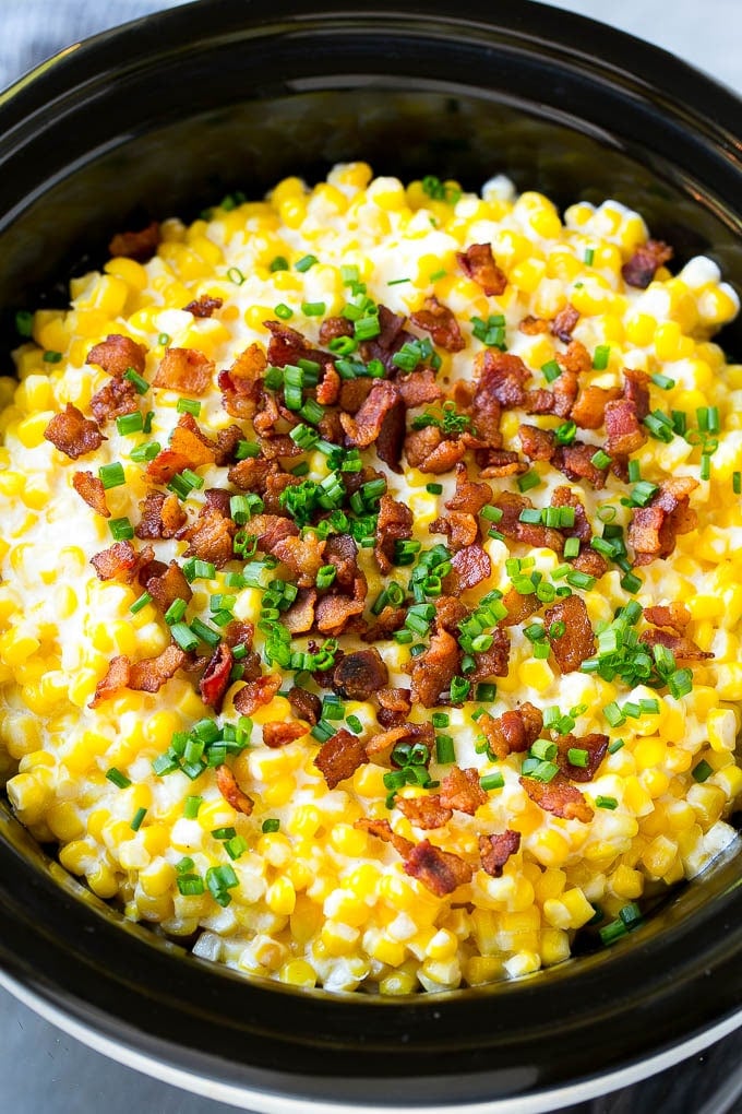 Slow Cooker Creamed Corn Recipe | Easy Creamed Corn Recipe | Slow Cooker Creamed Corn with Bacon | Southern Creamed Corn | Creamed Corn with Cream Cheese #creamedcorn #corn #bacon #crockpot #slowcooker #dinner #edsug Slow cooker creamed corn topped with bacon and chives.