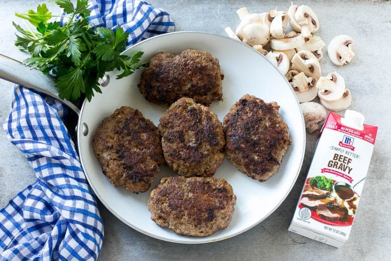 Slow Cooker Salisbury Steak Recipe | Homemade Salisbury Steak | Salisbury Steak from Scratch #steak #beef #salisbury #salisburysteak #slowcooker #crockpot #dinner #edsug Hamburger patties browned in a skillet.