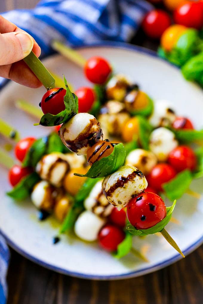 Caprese Skewers | Caprese Kabobs | Caprese Appetizer #tomato #mozzarella #basil #caprese #appetizer #edsug A kabob of mozzarella, tomatoes and basil drizzled with balsamic glaze.