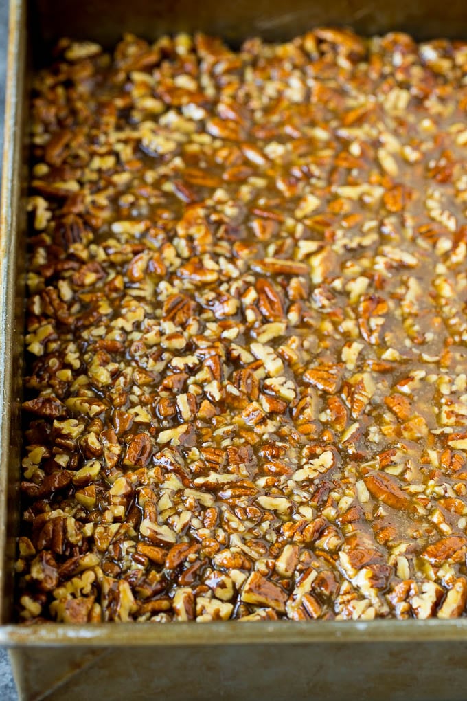 Pecan Pie Bars Recipe #pecans #pie #fall #pecanpie #dessert #thanksgiving #edsug Pecans and brown sugar poured over a cookie crust.