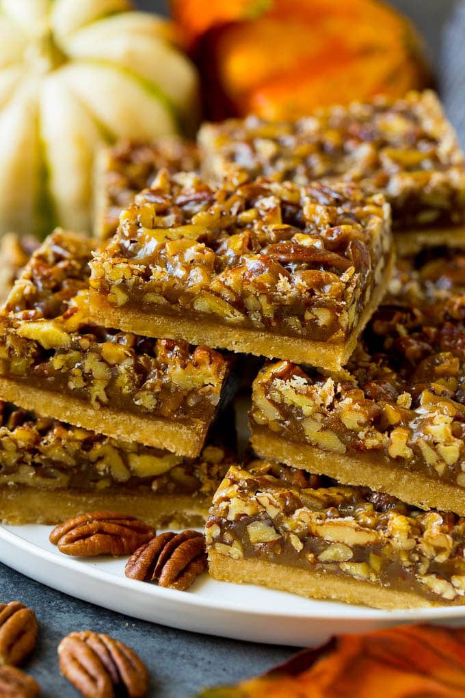 Pecan Pie Bars Recipe #pecans #pie #fall #pecanpie #dessert #thanksgiving #edsug A serving platter full of pecan pie bars.