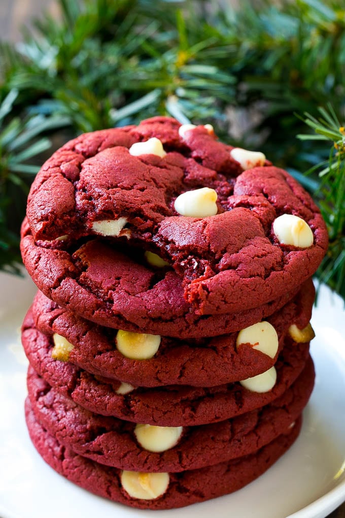 Red Velvet Cookies Recipe | Red Velvet Cookies with White Chocolate Chips | Red Velvet Cake Mix Cookies #redvelvet #cookies #whitechocolate #christmas #edsug A stack of red velvet cookies on a plate.
