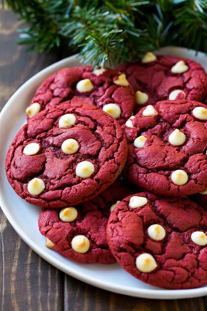 Red Velvet Cookies Recipe | Red Velvet Cookies with White Chocolate Chips | Red Velvet Cake Mix Cookies #redvelvet #cookies #whitechocolate #christmas #edsug Red Velvet Cookies on a serving plate with holiday decorations nearby,