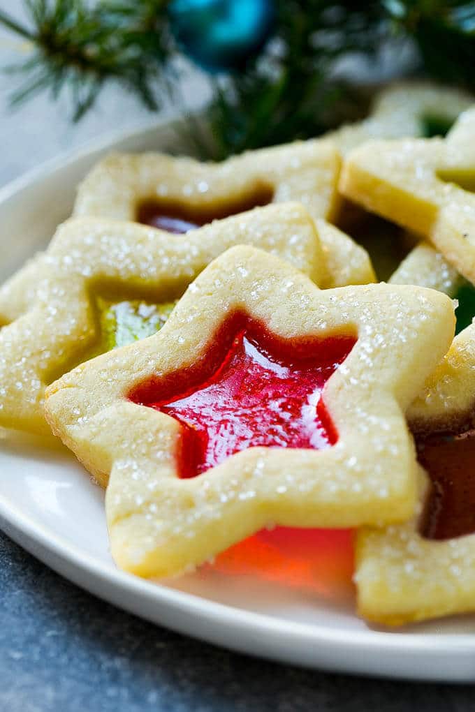 Stained Glass Cookies | Stained Glass Window Cookies | Christmas Cookies | Sugar Cookies | Holiday Cookies #cookies #stainedglasscookies #sugarcookies #christmascookies #christmas #holiday #dessert #edsug A star shaped cookie on a serving plate.