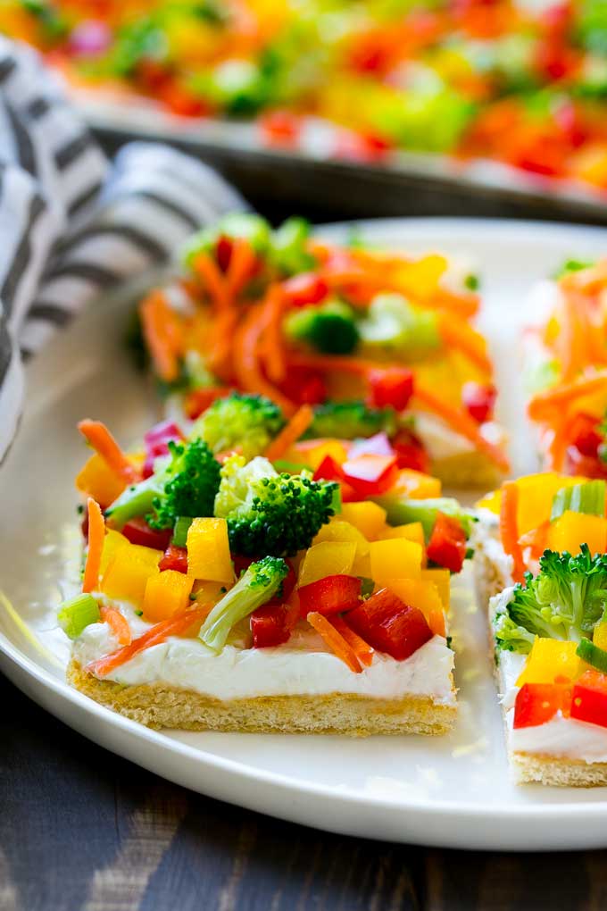 Veggie Pizza Recipe | Crescent Veggie Pizza | Vegetable Pizza Recipe | Holiday Appetizer | Homemade Veggie Pizza #pizza #veggies #vegetarian #appetizer #edsug Slices of veggie pizza on a serving plate.