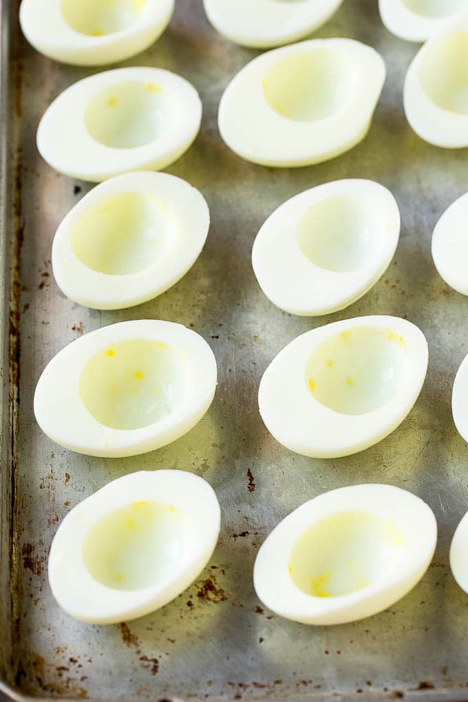 Bacon Deviled Eggs | Deviled Eggs Recipe #eggs #keto #lowcarb #bacon #appetizer #edsug Egg white halves on a sheet pan.