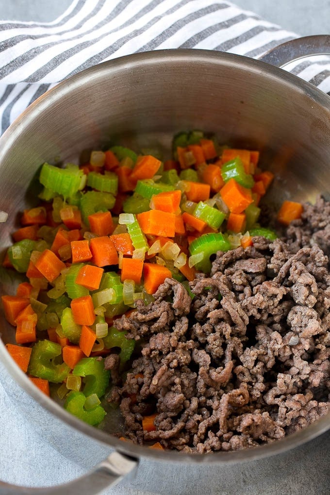 Hamburger Soup Recipe | Hamburger Stew | Ground Beef Soup #hamburger #soup #groundbeef #stew #dinner #edsug Ground beef is added to the vegetables in a pot.