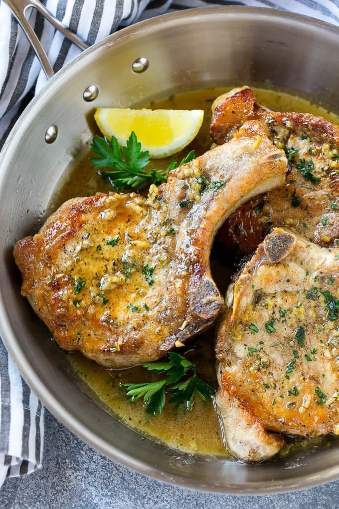Brown Sugar Pork Chops Recipe | Bone In Pork Chops Recipe | Garlic Butter Pork Chops | Skillet Pork Chops #pork #porkchops #garlic #dinner #glutenfree #edsug Brown sugar pork chops with garlic, butter and herbs in a frying pan.