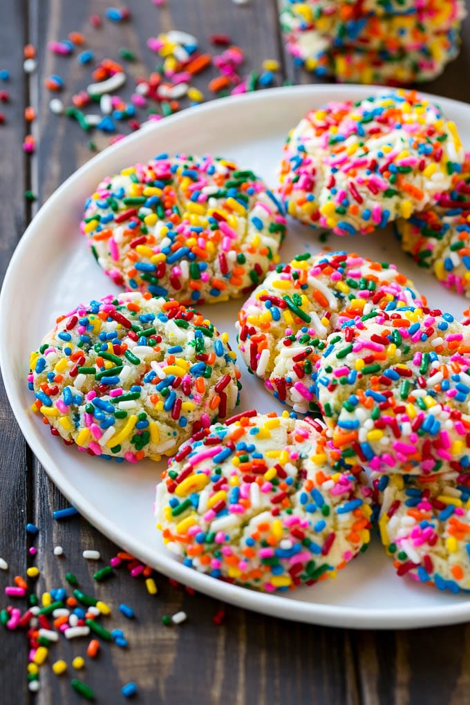 Funfetti Cookies Recipe | Funfetti Cake Mix Cookies | Sprinkle Cookies | Cake Mix Cookies #cookies #funfetti #sprinkles #dessert #edsug A plate of funfetti cookies coverd in rainbow sprinkles.