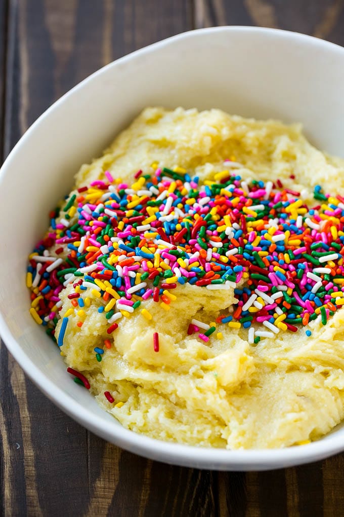 Funfetti Cookies Recipe | Funfetti Cake Mix Cookies | Sprinkle Cookies | Cake Mix Cookies #cookies #funfetti #sprinkles #dessert #edsug Cookie dough in a bowl with sprinkles on top.
