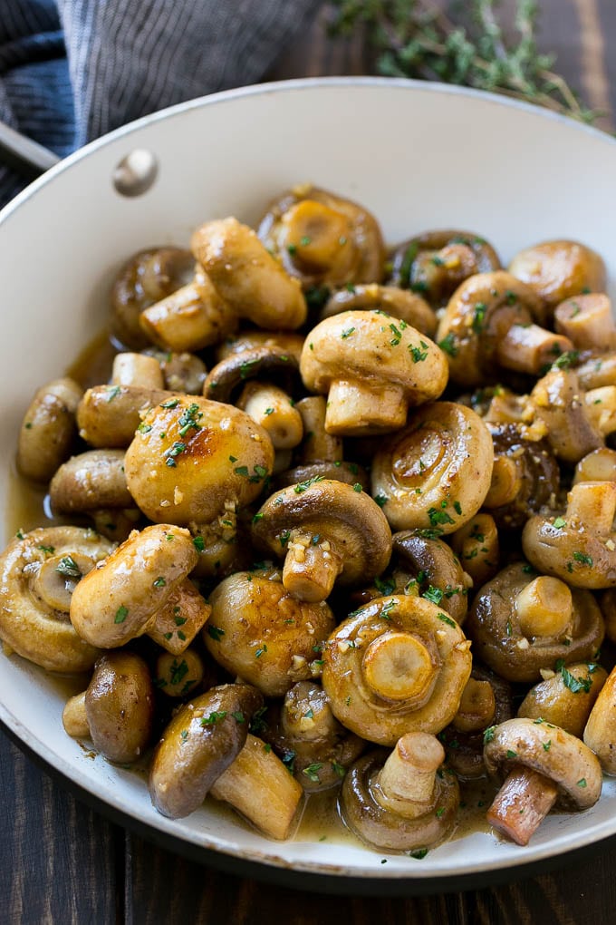 Garlic Mushrooms Recipe | Steakhouse Mushrooms | Sauteed Mushrooms | Garlic Butter Mushrooms | Mushroom Side Dish #mushrooms #butter #keto #lowcarb #dinner #sidedish #edsug A pan full of cooked mushrooms coated in garlic butter.