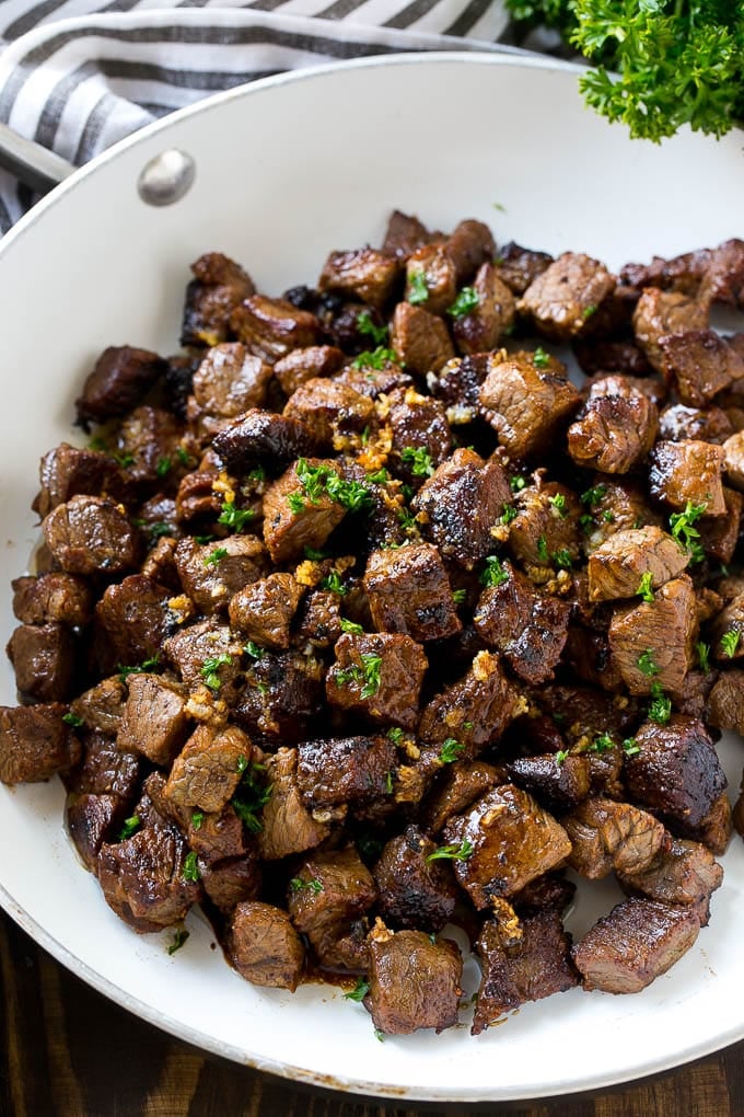 Steak Bites in Garlic Butter Recipe | Garlic Steak | Sirloin Steak Recipe | Steak Appetizer #steak #lowcarb #keto #edsug #dinner A frying pan of beef cubes tossed in garlic butter.