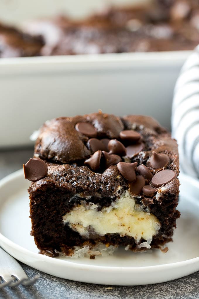 Earthquake Cake Recipe | Chocolate Cake Recipe | Chocolate Coconut Cake | Coconut Pecan Cake #cake #chocolate #coconut #pecans #dessert #chocolatecake #edsug A slice of earthquake cake on a plate.