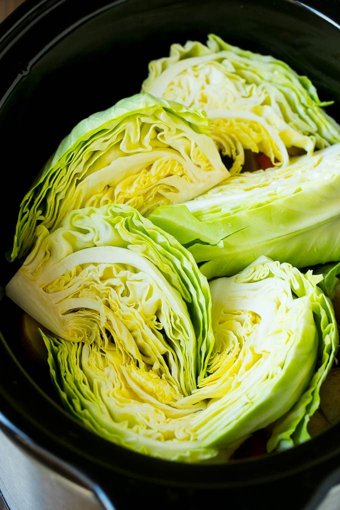 Slow Cooker Corned Beef Recipe | Crock Pot Corned Beef | Corned Beef and Cabbage #beef #cornedbeef #cabbage #potatoes #carrots #stpatricksday #irish #edsug Cabbage wedges inside a crock pot.