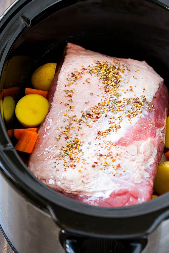 Slow Cooker Corned Beef Recipe | Crock Pot Corned Beef | Corned Beef and Cabbage #beef #cornedbeef #cabbage #potatoes #carrots #stpatricksday #irish #edsug A corned beef roast in a slow cooker with carrots and potatoes.