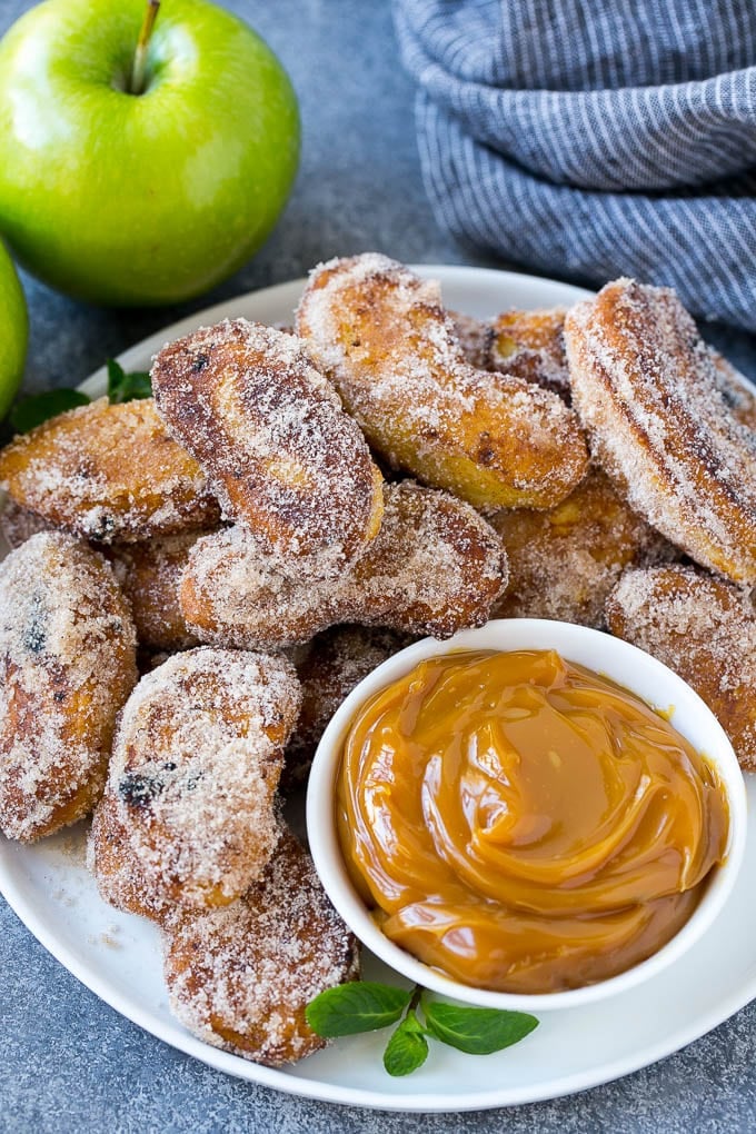 Apple Fries Recipe | Fried Apples Recipe | Cinnamon Sugar Apples | Apple Dessert Recipe #apples #dessert #edsug #fall A pile of cinnamon sugar apple fries with caramel sauce for dipping.