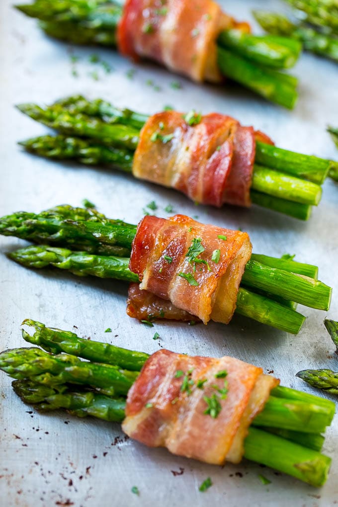 Bacon Wrapped Asparagus Recipe | Roasted Asparagus | Asparagus Side Dish #asparagus #bacon #sidedish #dinner #edsug Roasted asparagus in bundles on a sheet pan.