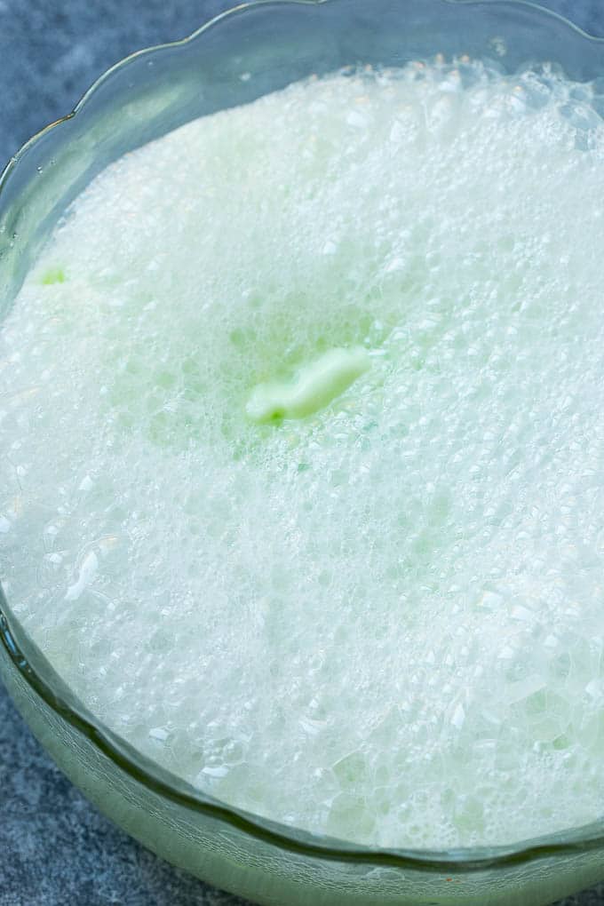 Lime Sherbet Punch | Party Punch Recipe | Sherbet Punch Recipe | Limeade Recipe #sherbet #punch #lime #drink #edsug Soda that has been poured into a large bowl.