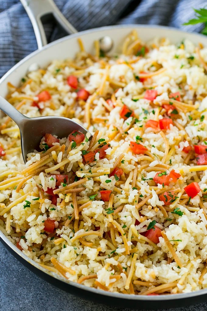 A skillet of chicken rice-a-roni made with pasta, rice and fresh tomatoes.