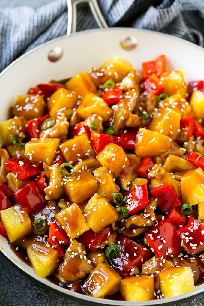 Pineapple Chicken | Hawaiian Chicken | Chicken Stir Fry #pineapple #chicken #dinner #stirfry #edsug Pineapple chicken stir fry in a skillet, topped with sauce, sesame seeds and green onions.