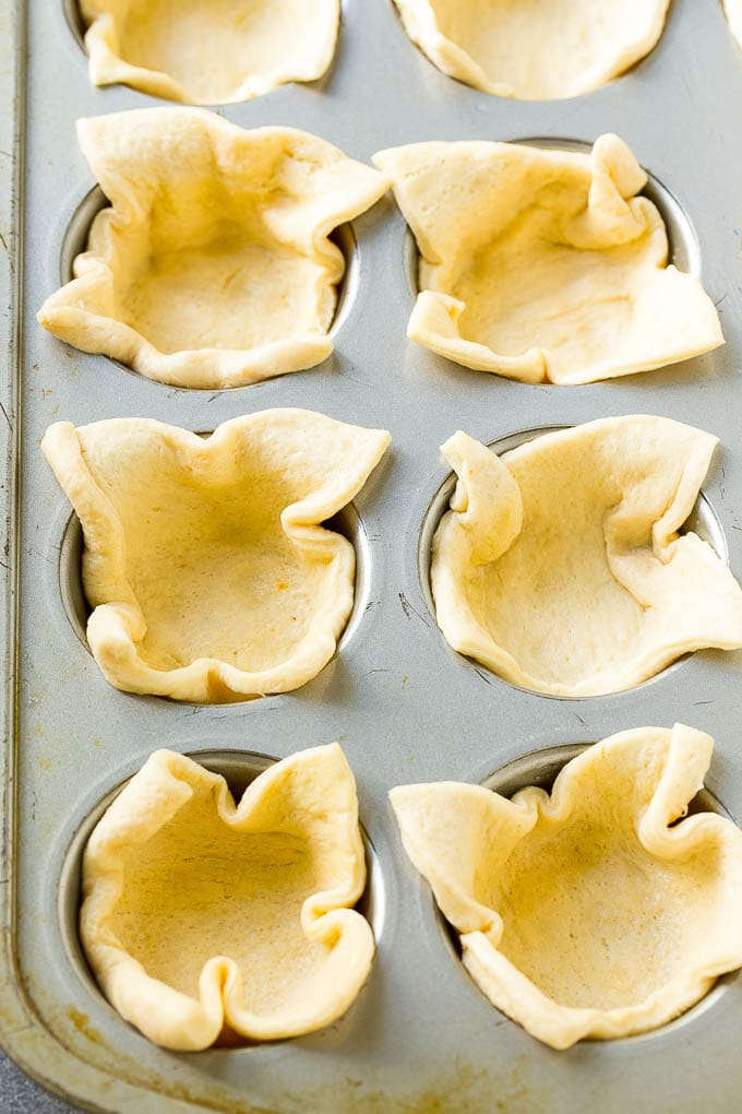 Pizza Muffins Recipe | Pizza Bites | Pizza Cups | Pizza Appetizer #pizza #appetizer #edsug Crescent roll dough pressed into a tin forms the crust.