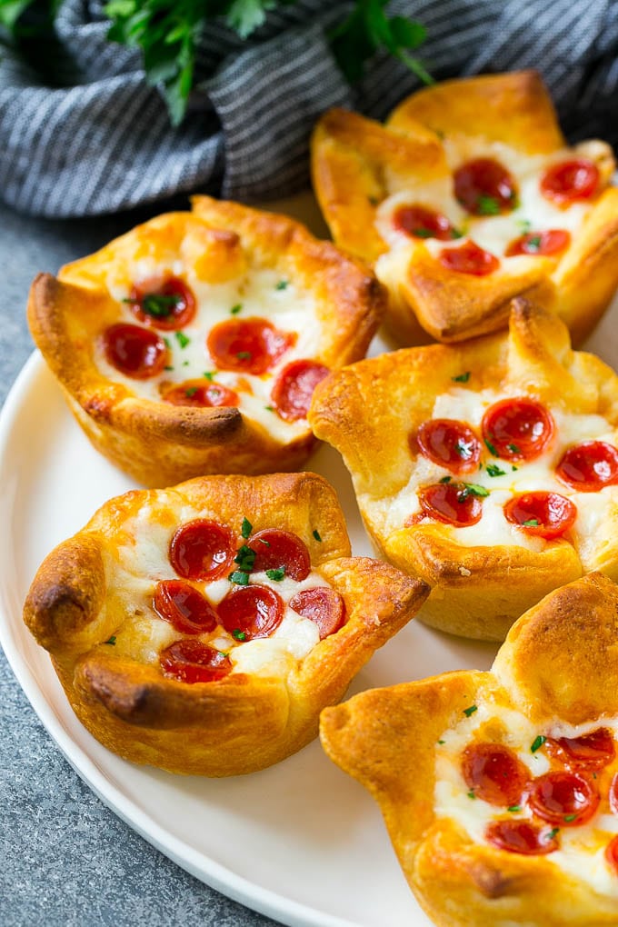 Pizza Muffins Recipe | Pizza Bites | Pizza Cups | Pizza Appetizer #pizza #appetizer #edsug A plate of pizza muffins made with crescent roll dough, pizza sauce, melted cheese and mini pepperoni.