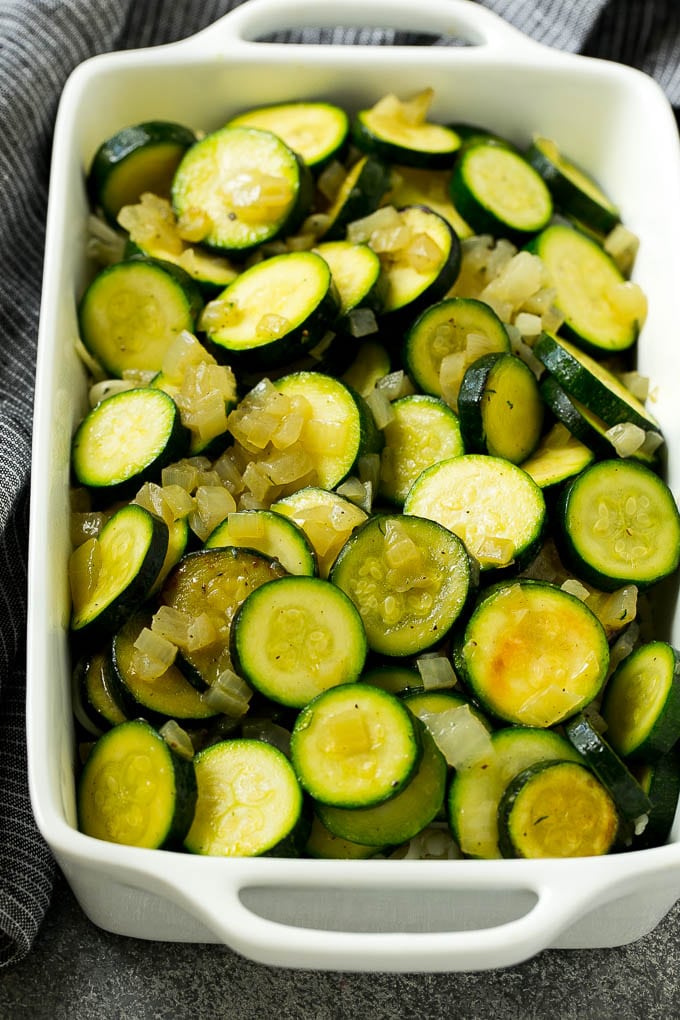Zucchini Gratin Recipe | Cheesy Zucchini | Baked Zucchini | Easy Zucchini Recipe #zucchini #casserole #cheese #dinner #sidedish #edsug Sauteed zucchini and onions in a baking dish.