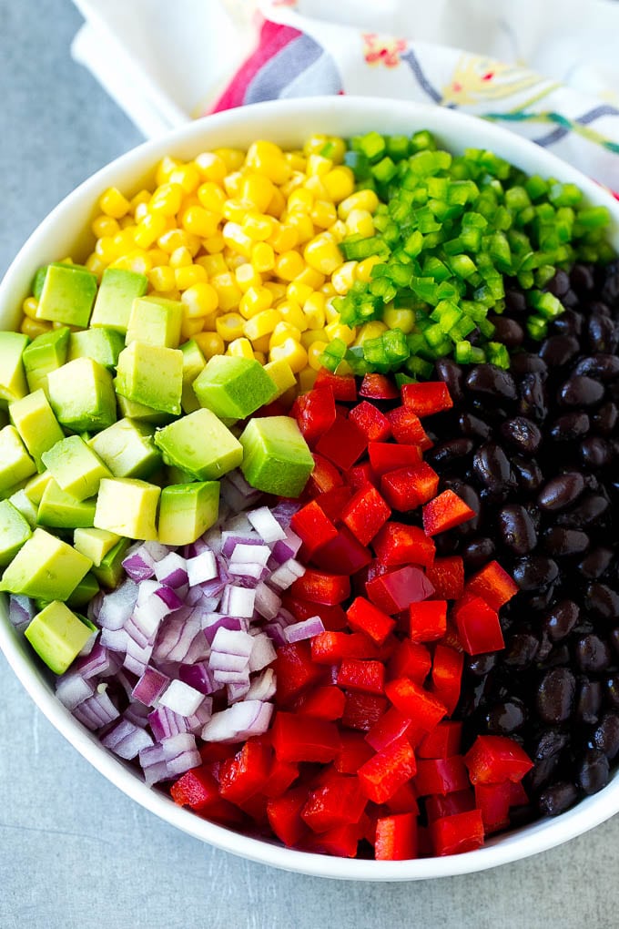 Black Bean and Corn Salad Recipe | Mexican Salad | Black Bean Salad | Bean Salad #salad #beans #corn #mexicanfood #edsug A bowl of beans, corn, diced red peppers, minced jalapeno, red onion and avocado.