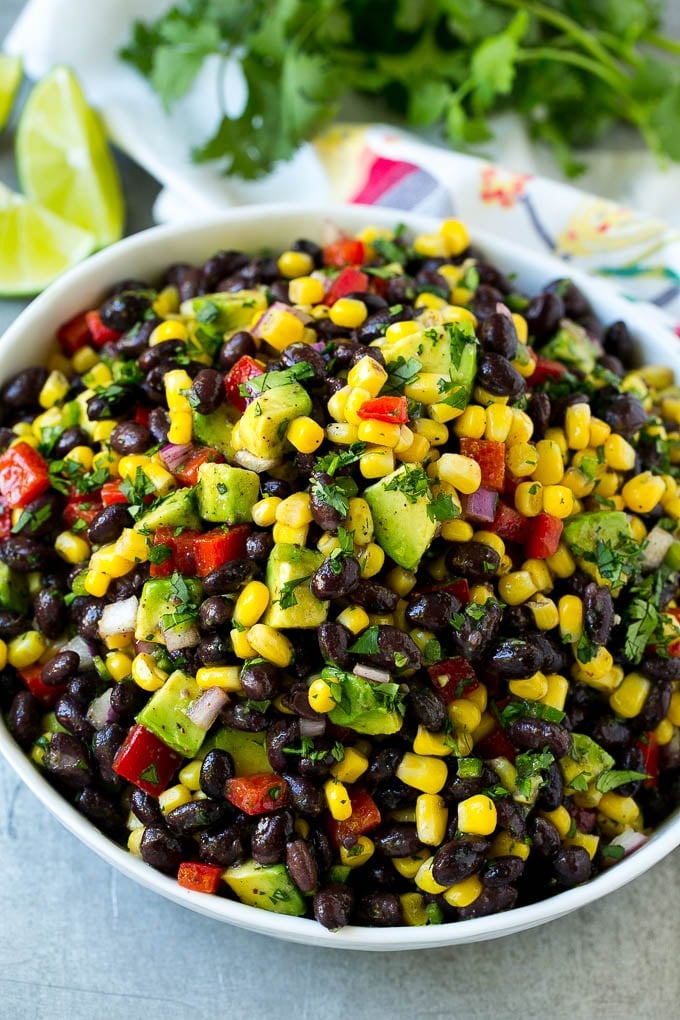 Black Bean and Corn Salad Recipe | Mexican Salad | Black Bean Salad | Bean Salad #salad #beans #corn #mexicanfood #edsug A serving bowl of black bean salad with corn, peppers and avocado.