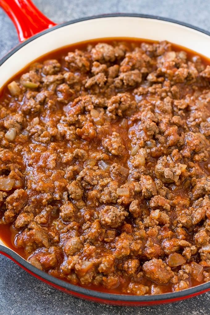 Ground beef, onions and tomato sauce in a skillet