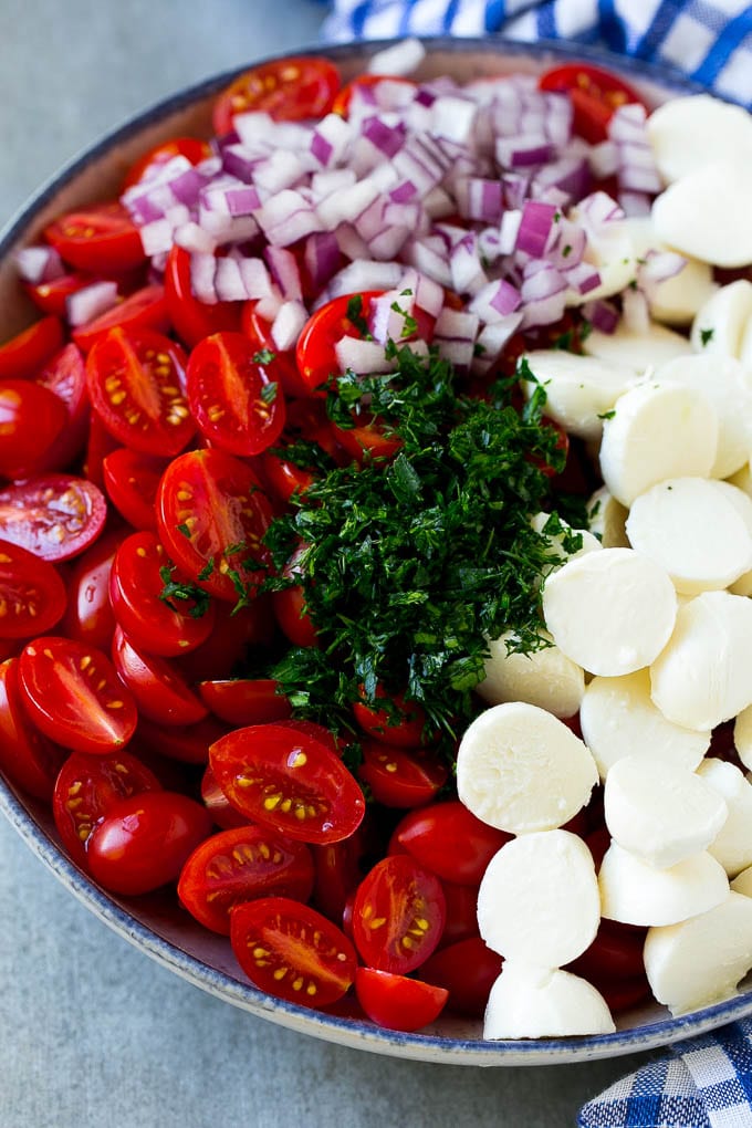 Cherry Tomato Salad Recipe | Tomato Mozzarella Salad | Caprese Salad | Tomato Salad #tomatoes #salad #tomatosalad #caprese #edsug A bowl of halved cherry tomatoes, mozzarella balls, herbs and minced red onion.