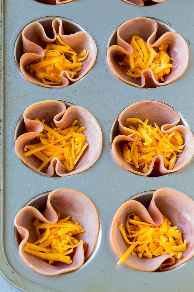 Ham and Egg Cups Recipe | Low Carb Breakfast | Ham and Eggs #ham #eggs #lowcarb #breakfast #edsug Ham pressed into muffin tins and topped with shredded cheese.