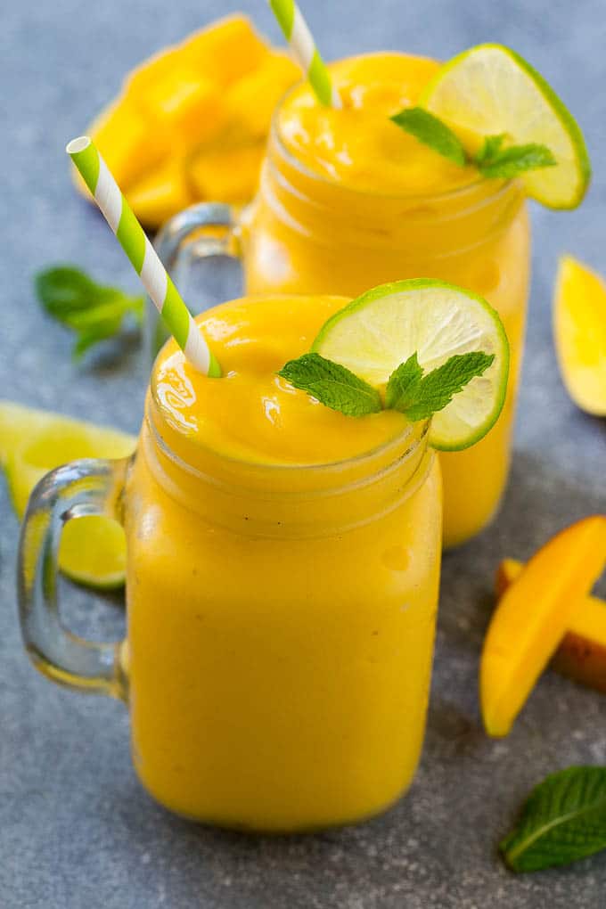 Mango Smoothie Recipe | Mango Recipe | Healthy Smoothie #mango #smoothie #drink #edsug Mango smoothie in a mug topped with a slice of lime and mint sprig.