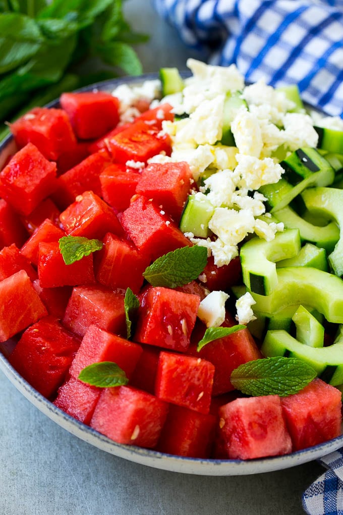 Watermelon Salad Recipe | Watermelon Feta Salad | Watermelon Cucumber Salad #watermelon #cucumber #salad #edsug A bowl of watermelon, cucumber, feta cheese and mint leaves drizzled with lime dressing.