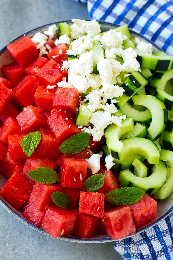 Watermelon Salad Recipe | Watermelon Feta Salad | Watermelon Cucumber Salad #watermelon #cucumber #salad #edsug A bowl of cubed watermelon, sliced cucumbers, feta cheese and mint leaves.
