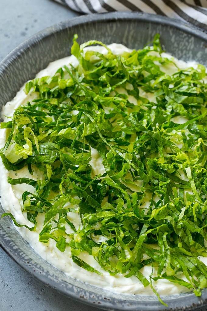 BLT Dip Recipe | Bacon Dip Recipe | Ranch Dip #dip #ranch #bacon #lettuce #tomato #appetizer #edsug Shredded romaine lettuce over a sour cream, cream cheese and ranch powder base.