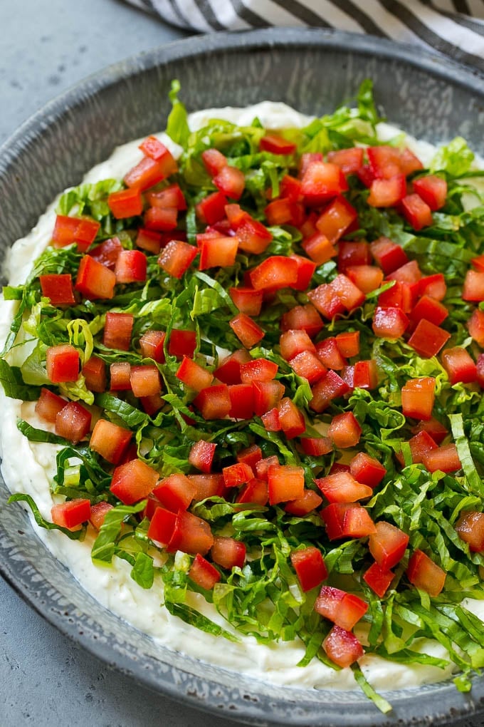 BLT Dip Recipe | Bacon Dip Recipe | Ranch Dip #dip #ranch #bacon #lettuce #tomato #appetizer #edsug Lettuce and tomatoes on top of ranch dip.