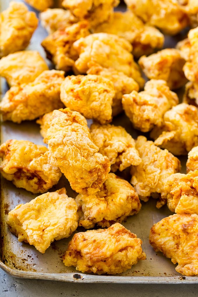 Sweet and Sour Chicken Recipe | Chinese Food Copycat Recipe | Chicken with Pineapple #chicken #chinesefood #pineapple #stirfry #takeout #dinner #edsug Fried pieces of chicken thighs on a sheet pan.