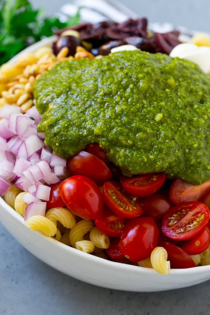 Pesto Pasta Salad | Italian Pasta Salad | Easy Pasta Salad #pasta #salad #pesto #olives #tomatoes #edsug Vegetables and corkscrew pasta topped with fresh pesto.