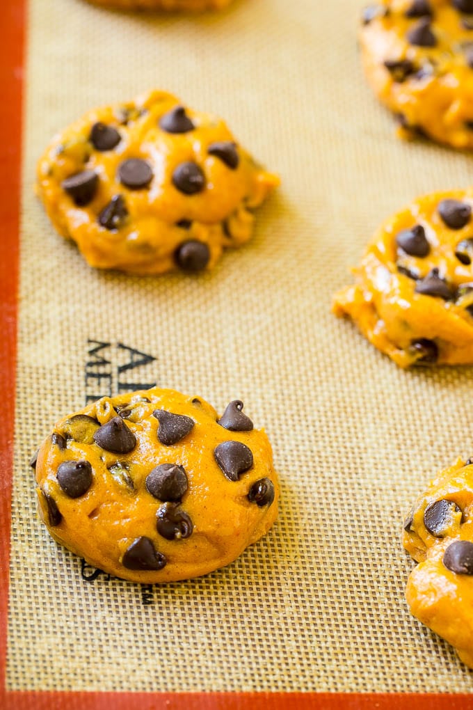 Pumpkin Chocolate Chip Cookies Recipe | Pumpkin Cookies | Pumpkin Chocolate Cookies #pumpkin #cookies #chocolate #baking #fall #edsug #dessert Dollops of dough on a baking sheet.